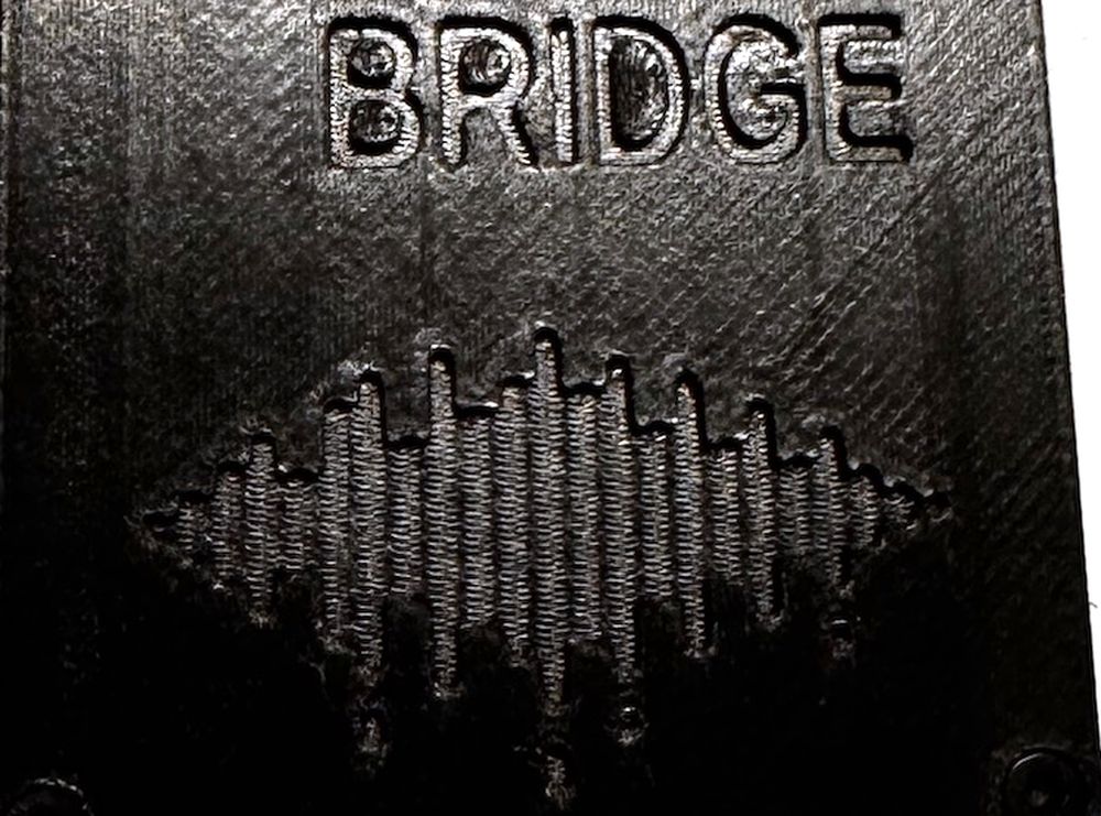 Close-up of the Fader Bridge enclosure: BRIDGE lettering, diagonal print layer lines